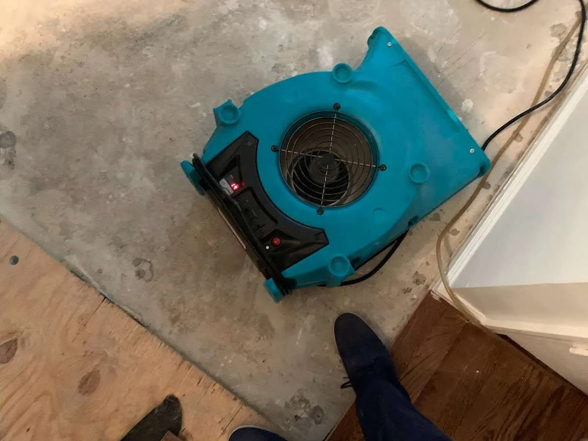 Air mover drying subfloor during Commercial Water Damage Restoration in South Charleston